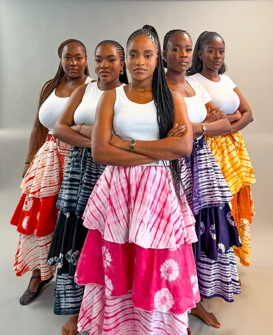 Five models wearing Adire Layered Skirts in every colourway